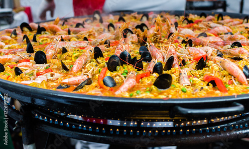 Seafood paella in a paella pan at a street food market photo