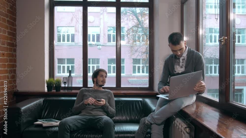 Young freelancers working at the modern office. Businessmans with devices, laptop and tablet in coworking. Young freelancers working at the modern office. Businessmans with devices, laptop and tablet in coworking.