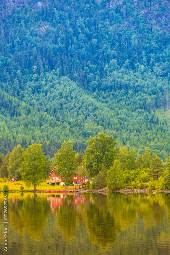 Norwegian country houses in mountains on lake shore