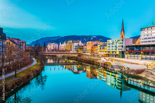 view of a riverside of river Drau during sunset in Villach, Austria photo