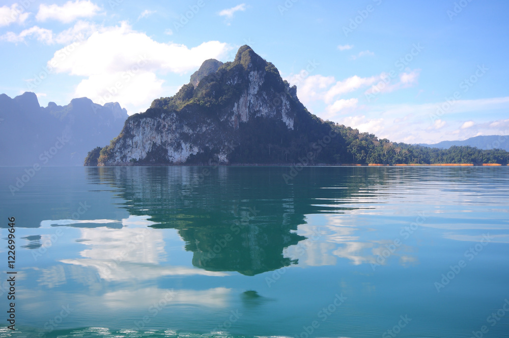 Beautiful scenery of the beautiful water reflection with clear sky at lake river in natural attractions,Ratchaprapha Dam at Khao Sok National Park,Surat Thani Province in Thailand.