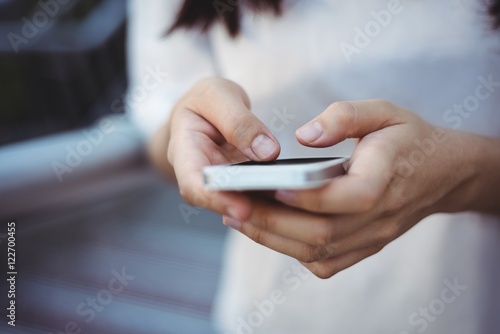 Woman text messaging on mobile phone photo