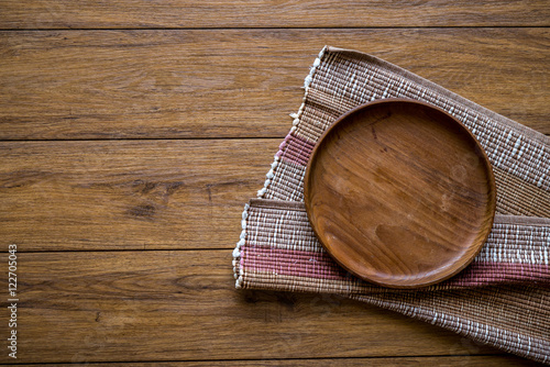 old wooden table with empty plate on a wooden table and copyspac