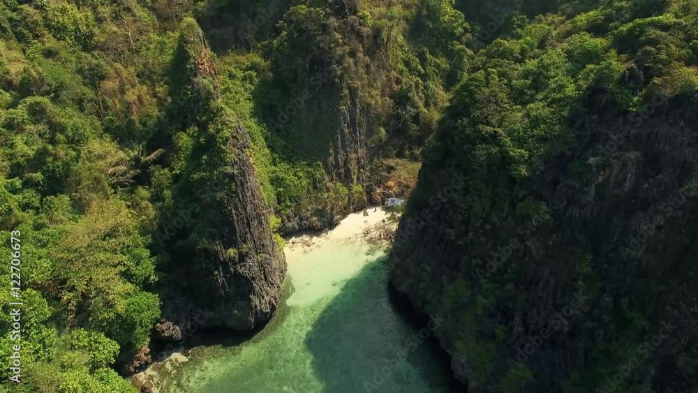 Aerial Video of a small beach in a bay between two rocky mountains in Thailand. N. Aerial Video of a small beach in a bay between two rocky mountains in Thailand. N.