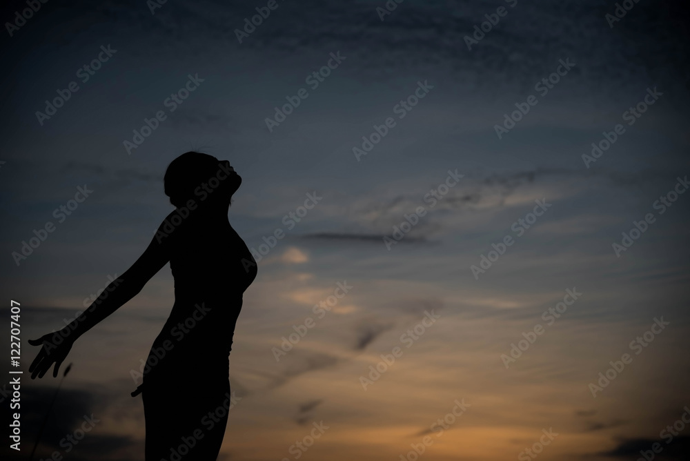 silhouette woman happy and sunset