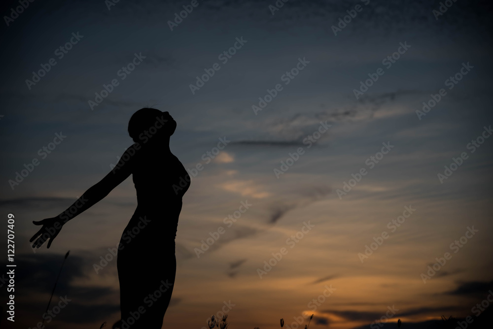 silhouette woman happy and sunset