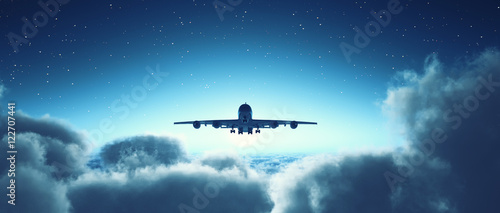 Fototapeta Naklejka Na Ścianę i Meble -  Airplane flying over cloudy sky.
