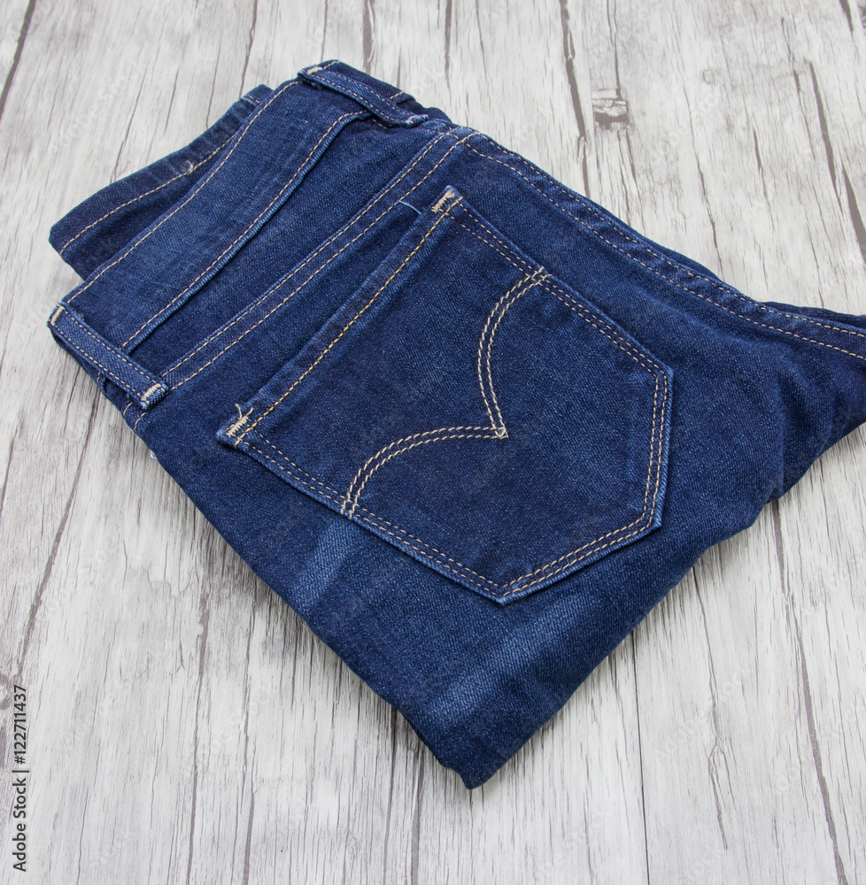 Blue jeans on wooden background. Blue jeans on wooden background.