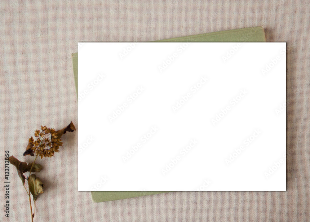 Mockup frame. White paper on green canvas. Yellowing leaves on sacking. Template, vintage design element. Mockup frame. White paper on green canvas. Yellowing leaves on sacking. Template, vintage design element.