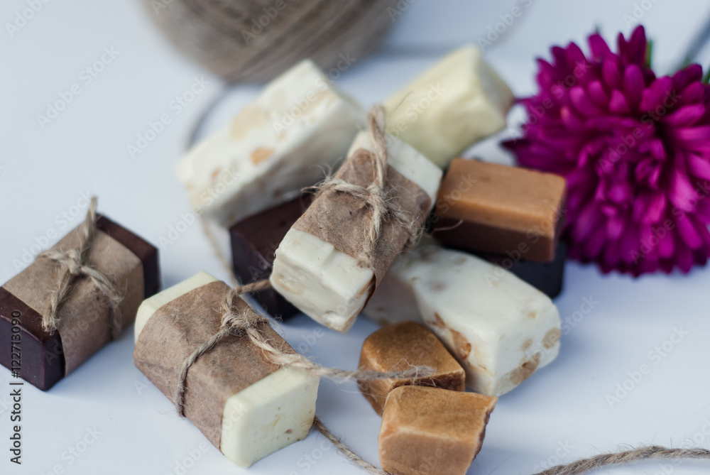 Italian nougat bars cut in pieces on white background