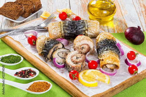 fillet of mackerel in rolls  tomatoes and lemon slices