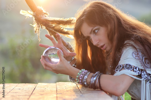 witch with crystal ball at sunset