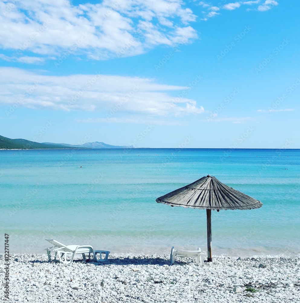 Sun umbrella and sunbed in saharun beach in croatia