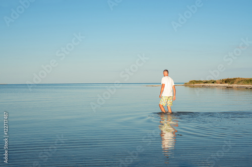 Man is walking in the sea