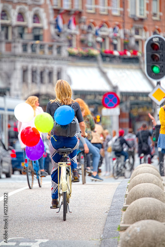 Girl with balloons ride to Amsterdam