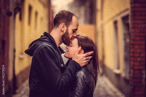 A man kissing cute brunette female in a head.