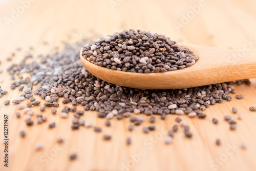 Close up of Chia seeds in a wooden spoon on the table