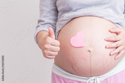 Wallpaper Mural Pregnant woman and paper heart on her belly Torontodigital.ca