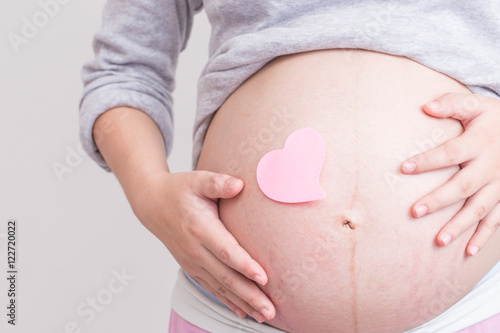 Wallpaper Mural Pregnant woman and paper heart on her belly Torontodigital.ca