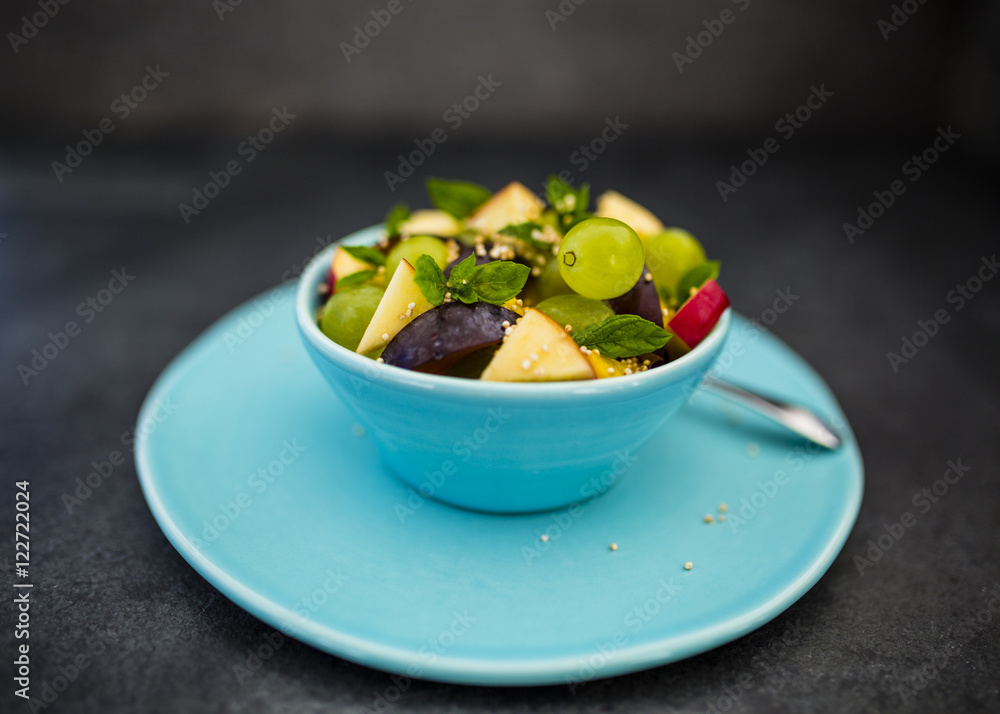 Healthy and delicious fruit salad with granola on stone background. Healthy and delicious fruit salad with granola on stone background.