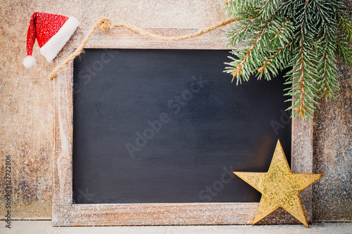 Christmas chalkboard with decoration. Santa hat, stars, Wooden