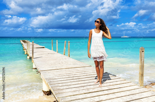 Photography Attractive young woman standing on the wooden pier