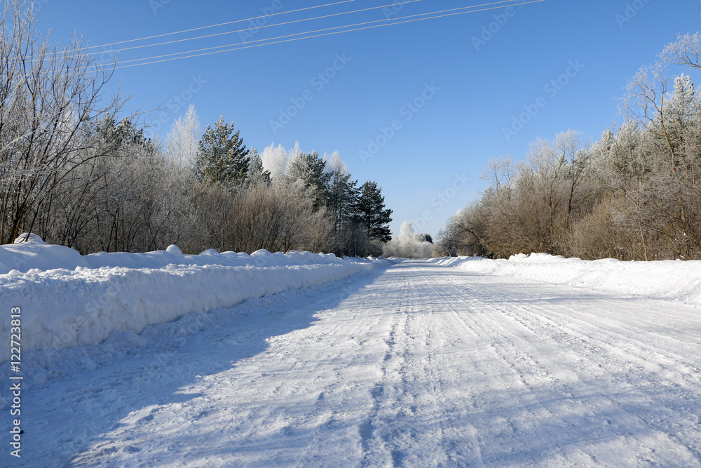 Road in snow in cold winter day Road in snow in cold winter day