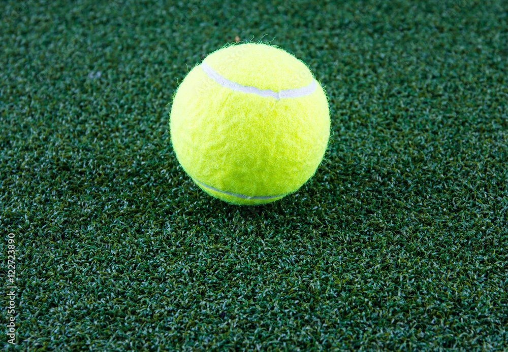 tennis ball on green grass background