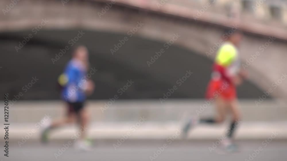 Blurred runners. Super slow motion background bokeh video Blurred runners. Super slow motion background bokeh video