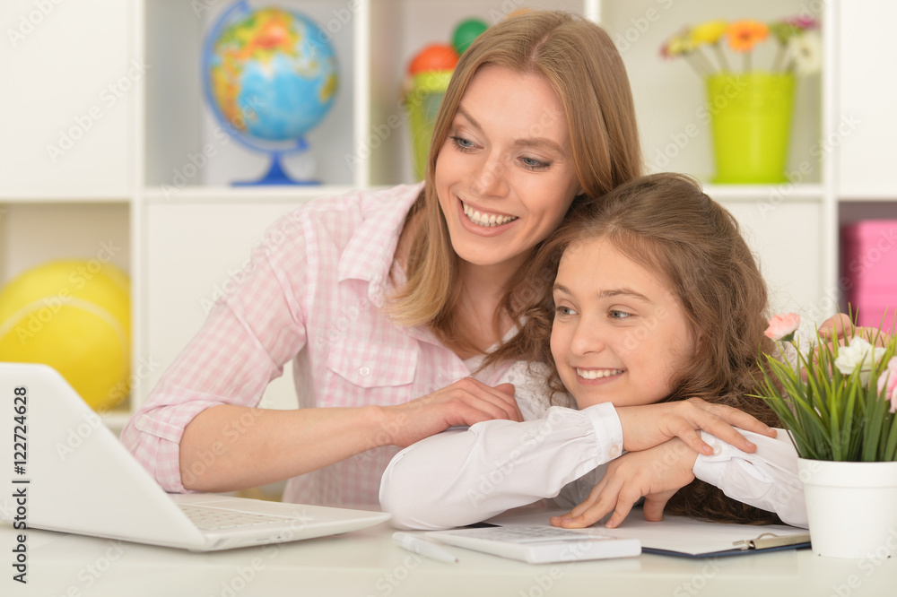mother and daughter using laptop mother and daughter using laptop