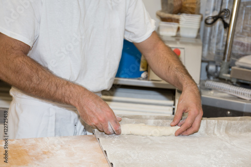 baker making bread , man hands , kneading a dough , cooking coat