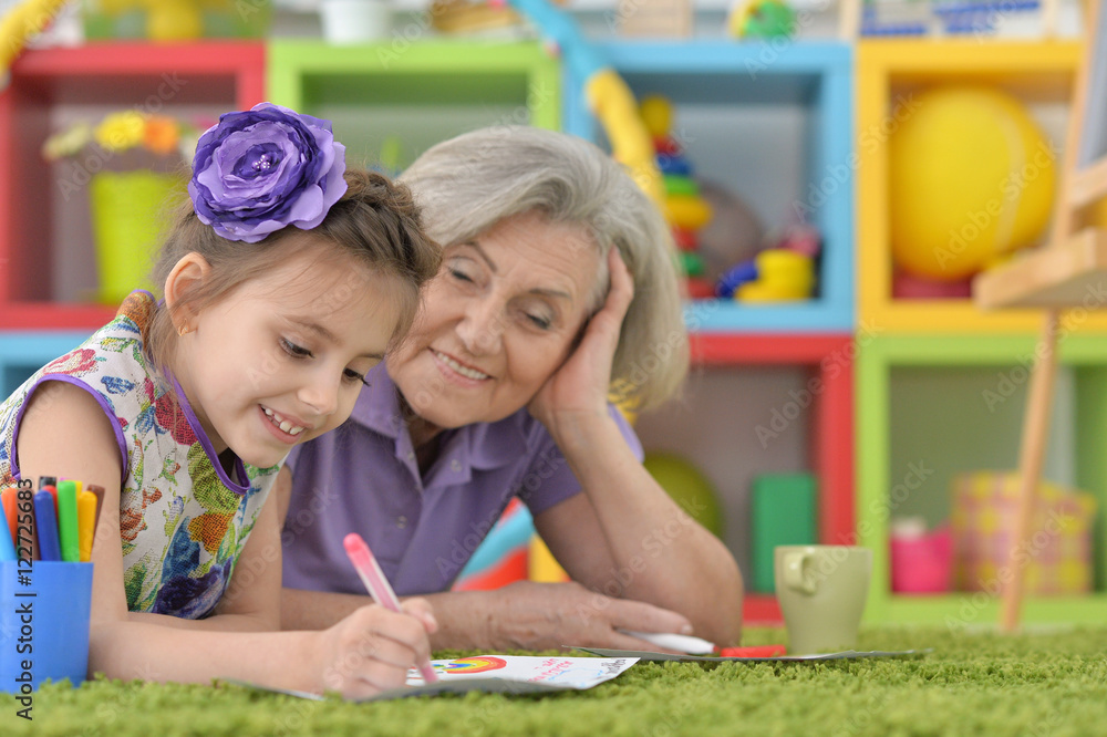 Grandmother with granddaughter drawing together Grandmother with granddaughter drawing together