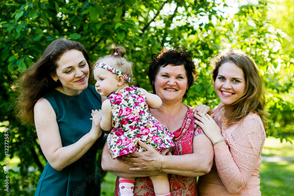 family portrait - mother, daughter and granddaughter posing in the Park family portrait - mother, daughter and granddaughter posing in the Park