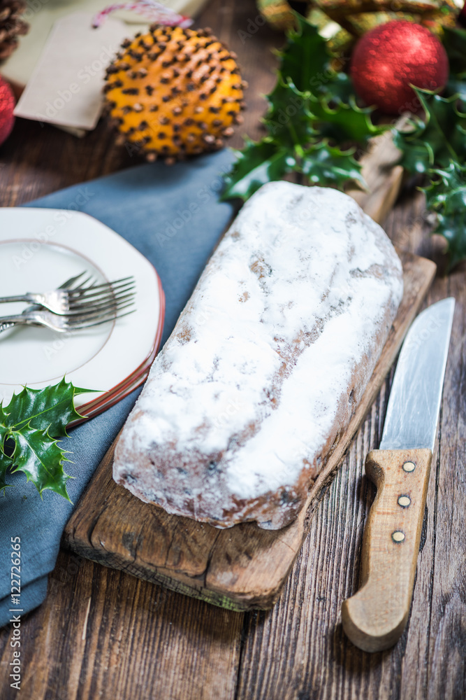 Christmas stollen cake on festive decorated table Christmas stollen cake on festive decorated table