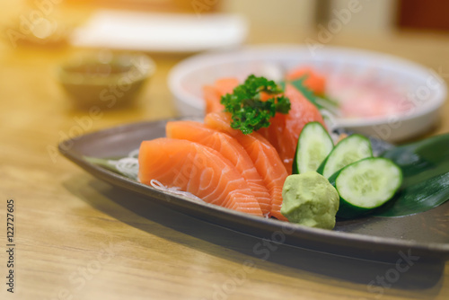 Salmon sashimi with Wasabi on pottery dish
