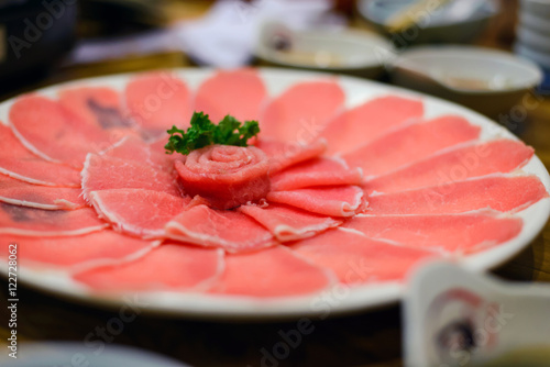 Fresh pork slice for shabu or sukiyaki on circle dish - Japanese food, raw food