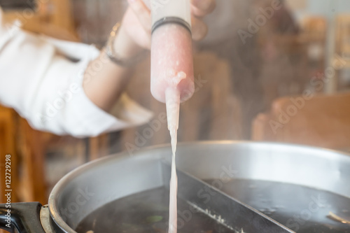 mince pork in syring into hot pot