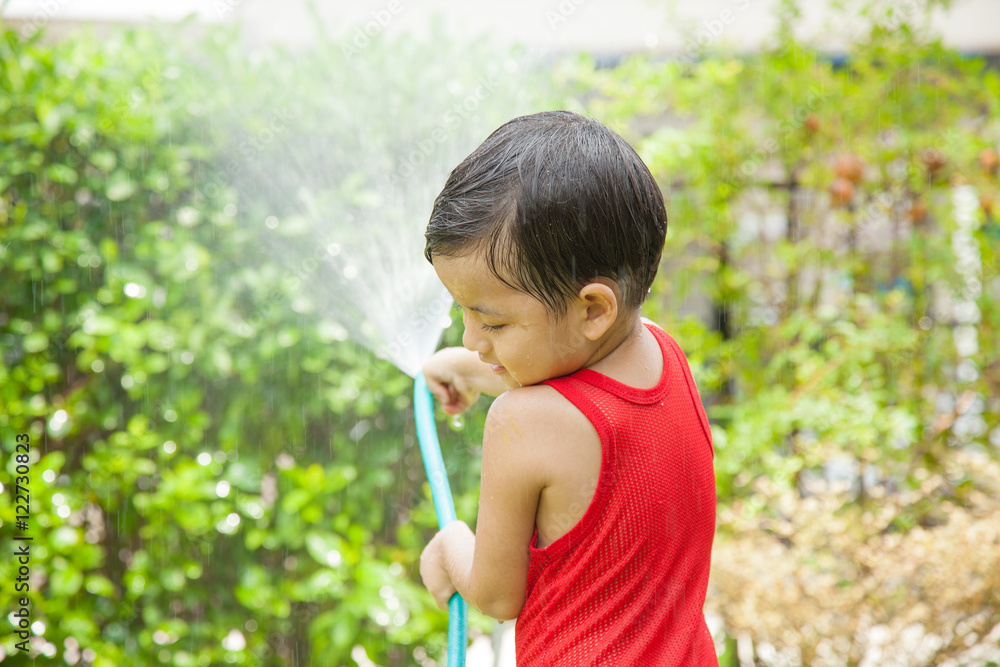 Little boy playing water splash Little boy playing water splash