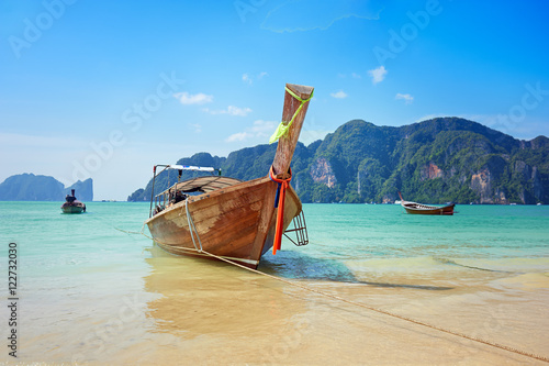 Longtail boat in the beautiful sea over clear sky