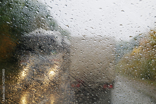 Raindrops on the windshield of the car.