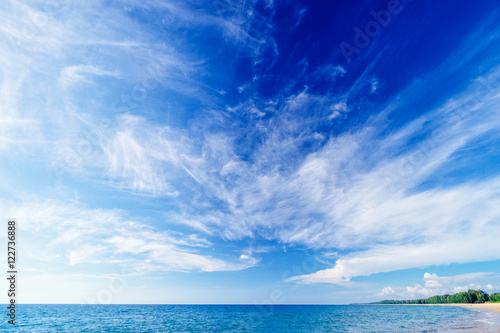 Beautiful seascape. Beach with blue cloudy sky.