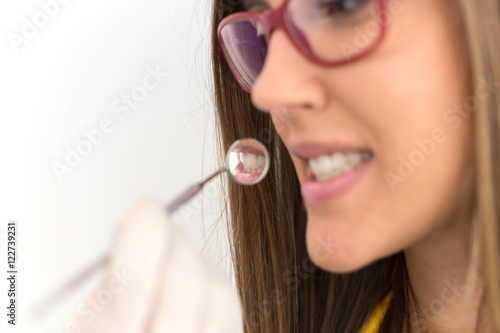 Patient's teeth reflection in the dentist mirror