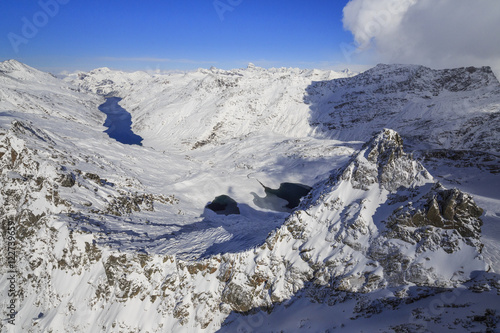 Aerial view of snowy Peak Peloso surrounded by Lago di Lei, Val di Lei Chiavenna, Spluga Valley, Valtellina, Lombardy photo