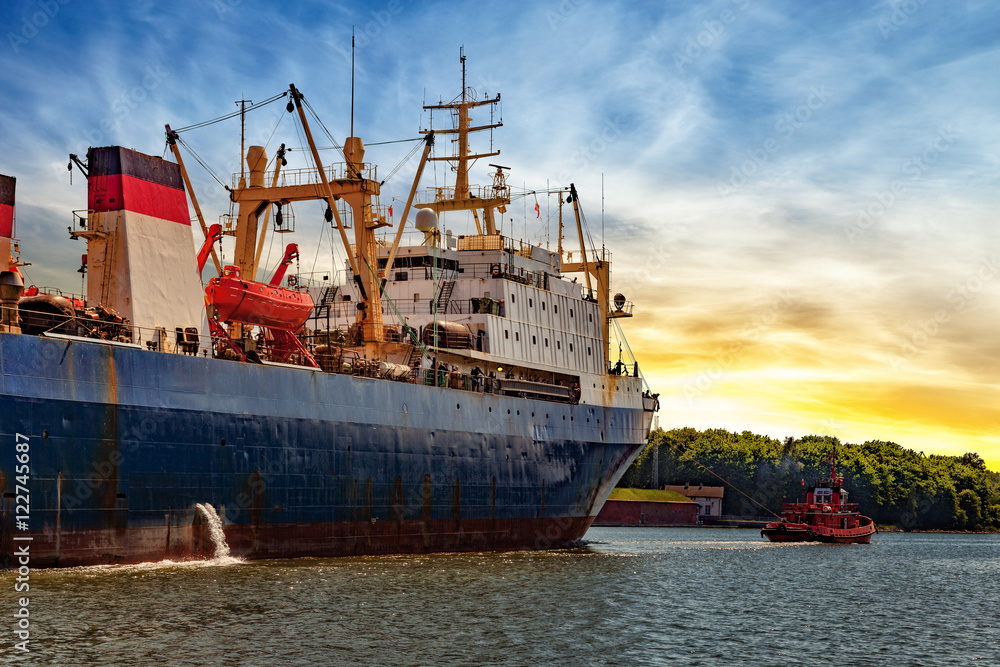 Tugboat towing fishing ship in port of Gdansk, Poland. Tugboat towing fishing ship in port of Gdansk, Poland.