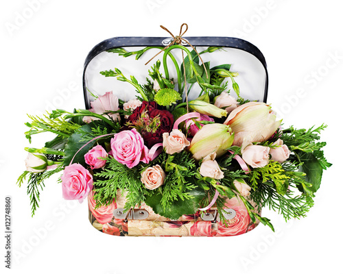 Colorful floral arrangement of roses and lilies in acardboard chest isolated on white background. photo