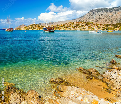 View of beautiful bay in   panormitis  Symi island , ships. and boats at anchor, Greece photo