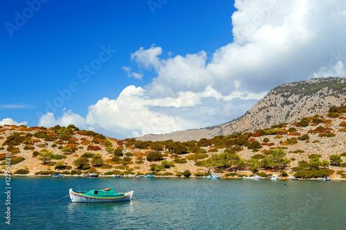 Sinking sailboat in shallow water after a storm on Simi island. Greece. Europe.