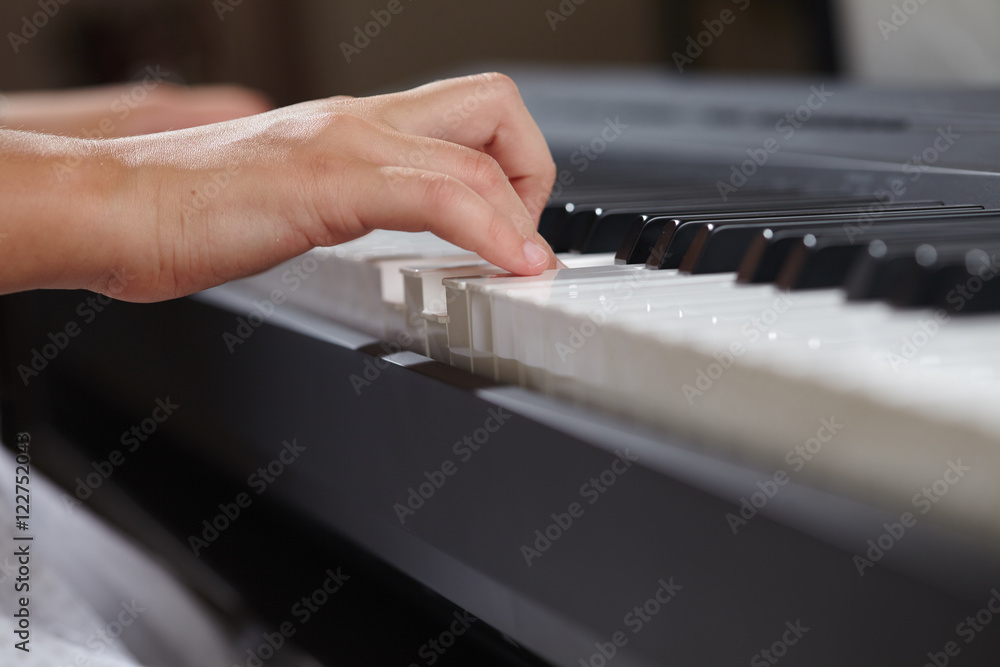 Fototapeta premium female's hands playing piano
