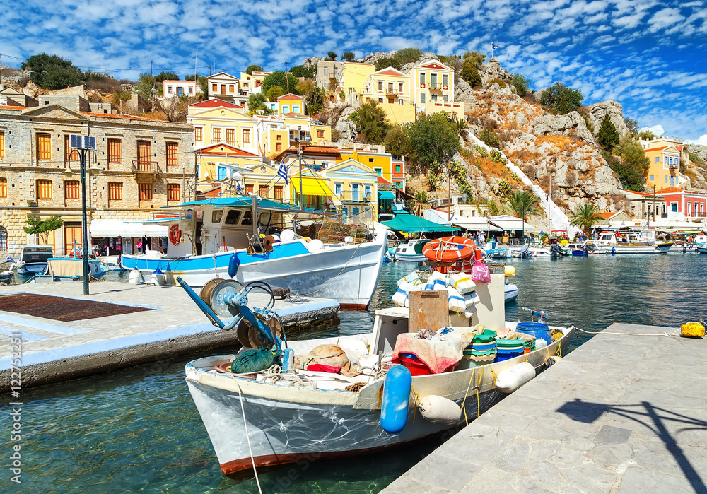 Old fishing boats docked in the gulf of Symi island in Greece