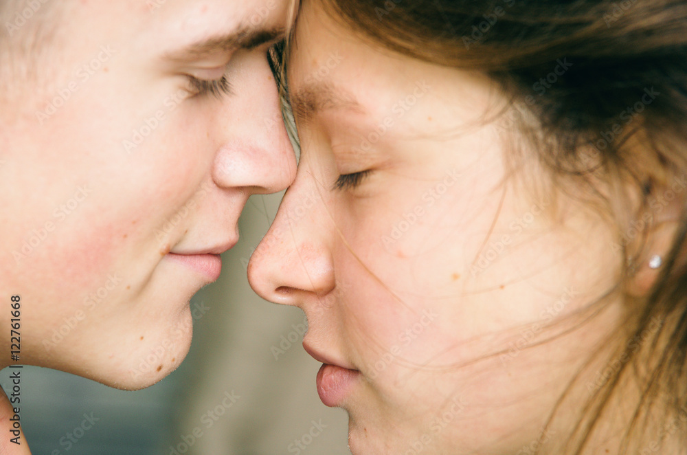 Young couple tenderly staring each other close up Young couple tenderly staring each other close up